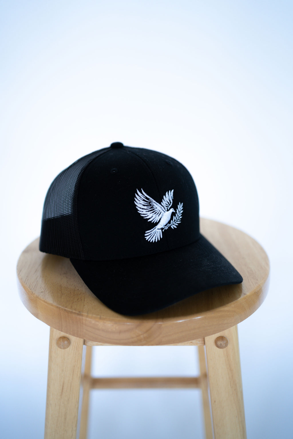 Black Trucker Style Hat with Dove Logo
